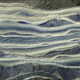 This composite image shows alternating layers of ice and sand in an area where they’re exposed on the surface of Mars. The water ice appears as light-colored, while the sand is darker blue.
